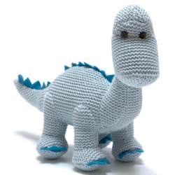 Best Years Knitted Organic Cotton Blue Diplodocus Dinosaur Baby Rattle. Made From 100% acrylic yarn with recycled polyester stuffing in a muted blue knitted body. Featuring teal felt claws and spikes along the back, with hand stitched eyes.