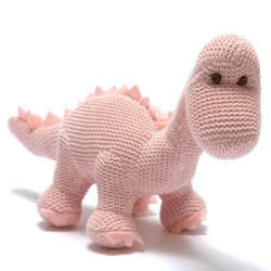 Best Years Pink Knitted Diplodocus Dinosaur Baby Rattle. Made From 100% organic cotton with a polyester stuffing. Coming in a soft, baby pink knitted style fur. Featuring matching pink felt claws and spikes along the back, with hand stitched eyes.