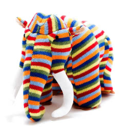 Best Years Woolly Mammoth Knitted Dinosaur Toy in Bright Stripes. Made from 100% acrylic yarn with recycled polyester stuffing in a bold multicoloured knitted body. Featuring brown felt toes, long white suede tusks, long trunk and  hand stitched eyes.