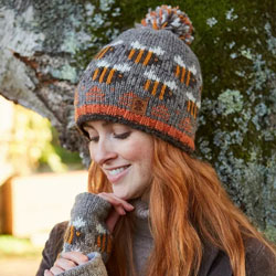 Pachamama Knitwear Beehive Bark Bobble Beanie Hat featuring bumble bees in on a grey-brown background, 100% Wool, fleece lined.