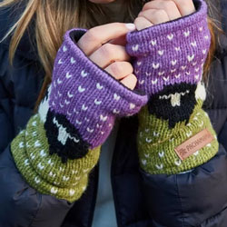 Pachamama Knitwear Black Sheep Handwarmer Purple fingerless gloves, featuring a black & white sheep pattern over a green & purple background.