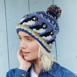 Pachamama Knitwear Circus of Puffins Bobble Beanie, handknitted, made from 100% wool with a fleece lined rim. They are knitted in Nepal using local wools and natural dyes to UK designs.