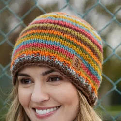Pachamama Knitwear Grassington Beanie hat, features bright earthy stripes, hand-knitted, 100% wool, fleece lined.