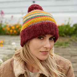 Pachamama Knitwear Grassington Bobble Beanie hat featuring earthy handknitted stripes using 100% wool, fleece lined forehead.