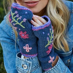 Pachamama Knitwear Hampton Court Handwarmer fingerless gloves, features a navy-blue background with embroidered pink, lilac and green flowers.
