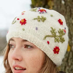 Pachamama Knitwear Lugano Beanie Cream hat featuring hand embroidered flowers on a cream background, 100% wool, fleece lined. 