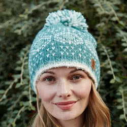 Pachamama Pentle Bay Bobble Beanie. These hand knitted wool bobble beanie hats are sherpa fleece lined for comfort. Coming in a striking shade of duck egg blue with floral fair isle patterns..Every design is subtly different from the next one so you are a