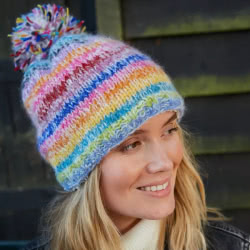 Pachamama Knitwear San Francisco Bobble Beanie Hat features rainbow stripes, 100% Wool, fleece lined.
