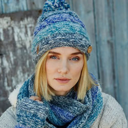Pachamama Knitwear Sierra Nevada Bobble Beanie Blue, handknitted from wool and mohair, with a fleece lining and coconut button detail.