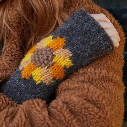 Pachamama Knitwear Sunflower Handwarmer fingerless gloves, featuring a sunflower design in orange, yellow & brown, 100% wool, fleece lined.