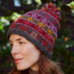 Pachamama Knitwear Tintagel Fine Knit Bobble Beanie hat featuring knitted stars in rich earthy colours, 100% wool, fleece lined