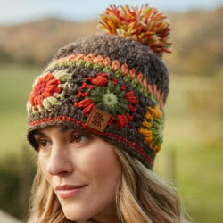 Pachamama Knitwear Woodstock Bobble Beanie Earth hat with hand crocheted traditional squares in warm, earthy tones. Please note, as they are handmade, each piece may vary slightly in size and appearance.