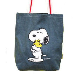 Peanuts Snoopy Love Stonewash Tote. This stylish blue denim tote bag features iconic Peanuts character Snoopy hugging his best friend Woodstock. It has strong straps with red, pink and white stripes, and features an illustration of Snoopy and Woodstock on
