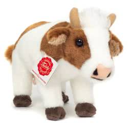 Introducing Teddy Hermann Cow brown and white soft toy   in a 23 cm size. Coming in a standing position with a soft cream fur body with brown patches, dark brown hoofs, pink nose, udders, beige horns and fluffy white hair.