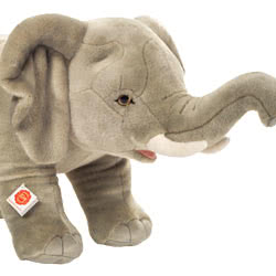 Teddy Hermann standing Elephant in a 60 cm size. This is a rigid, life-like standing elephant. Coming in a grey, short fur body with extended trunk, two short white tusks and beautiful large ears.