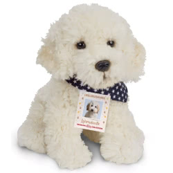 Teddy Hermann sitting Labradoodle soft toy in a 28 cm size. Coming with cuddly cream fur, small floppy ears, a black button nose and seriously cute looks! Featuring a fashionable navy scarf with a star pattern.