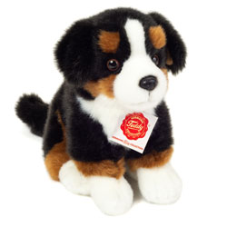 Teddy Hermann sitting Bernese Mountain Dog soft toy in a 21 cm size. This beautiful canine features traditional Bernese Mountain dog characteristics, with soft white, brown and black fluffy fur, a little tail, glossy eyes, button nose, and floppy ears.