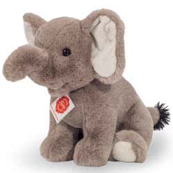 Teddy Hermann sitting Elephant soft toy in a 25 cm size. Featuring the softest grey fur, with suede inner ears, a tasselled tail and the most adorable, cute looks. This is a proper chunky, well-made soft toy.